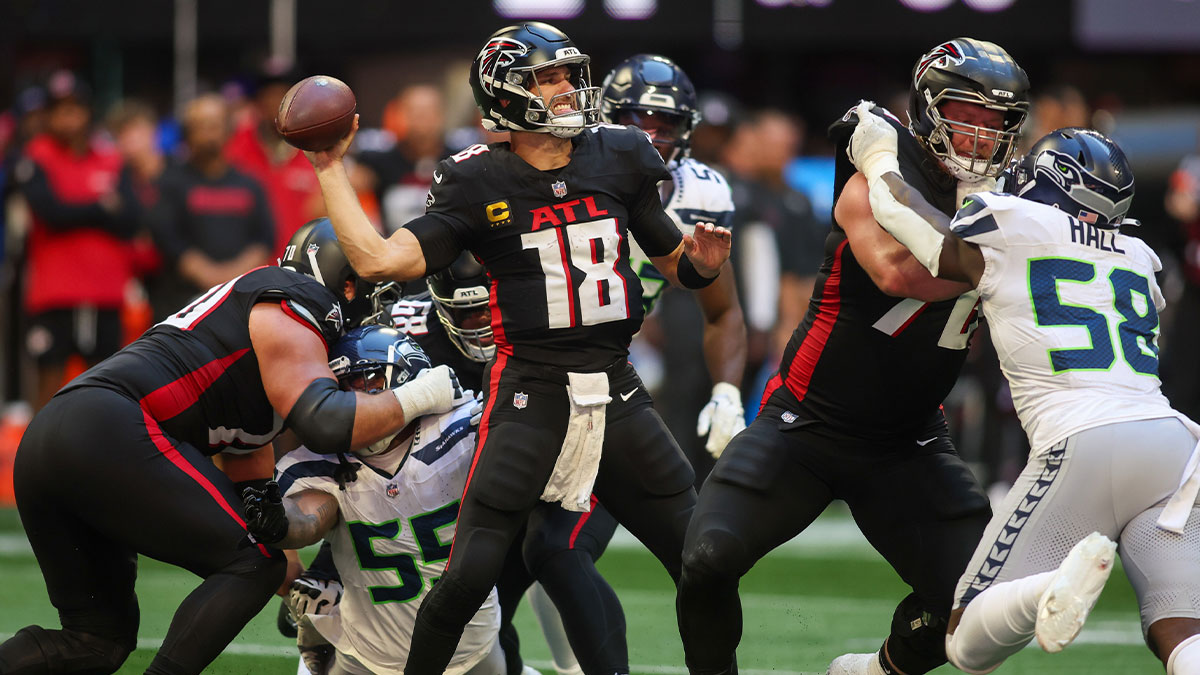 Atlanta Falcons quarterback Kirk Cousins (18) throws a pass against the Seattle Seahawks in the fourth quarter at Mercedes-Benz Stadium.