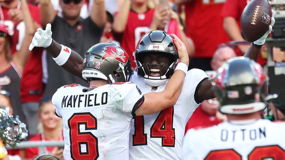 Sep 8, 2024; Tampa, Florida, USA; Tampa Bay Buccaneers wide receiver Chris Godwin (14) is congratulated by quarterback Baker Mayfield (6) after he scored a touchdown against the Washington Commanders during the second half at Raymond James Stadium.