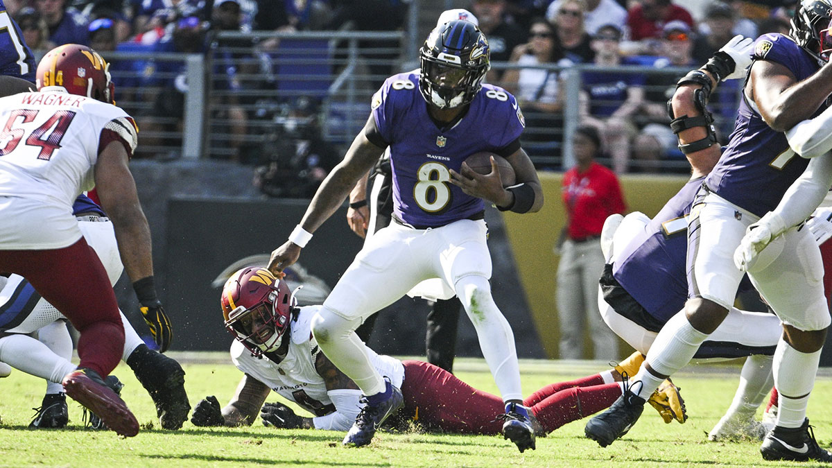 Baltimore Ravens quarterback Lamar Jackson (8) rushes during the second half against the Washington Commanders at M&T Bank Stadium. 