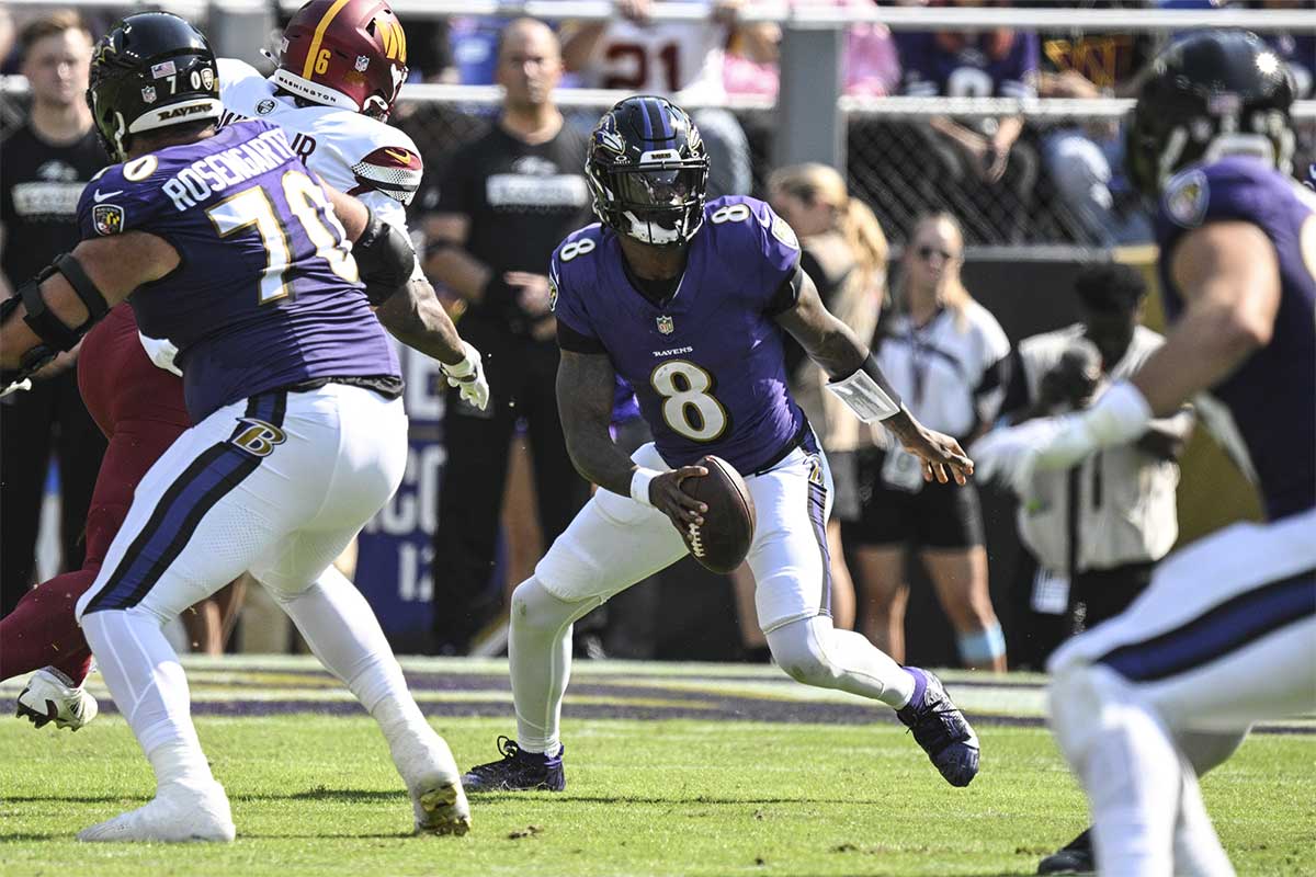 Baltimore Ravens quarterback Lamar Jackson (8) looks to run during the first quarter against the Washington Commanders at M&T Bank Stadium.