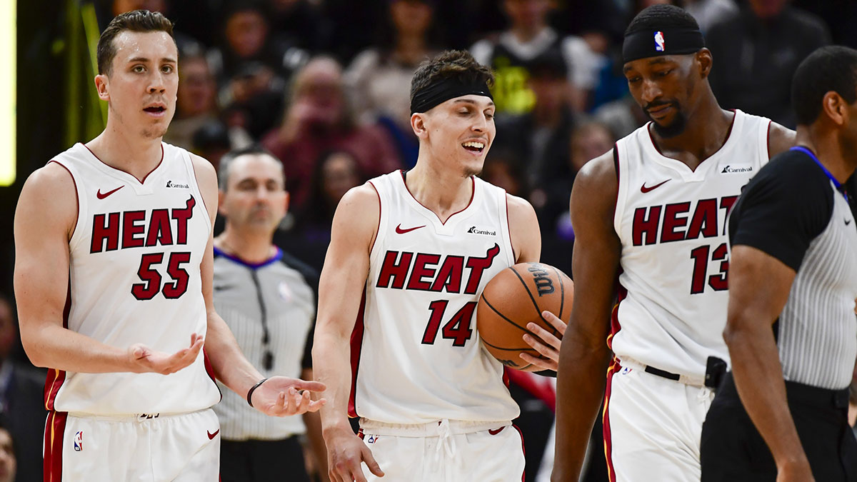 Miami Heat forward Duncan Robinson (55), center/forward Bam Adebayo (13), and guard Tyler Herro (14) react after a call against the Utah Jazz during the second half at Vivint Arena.