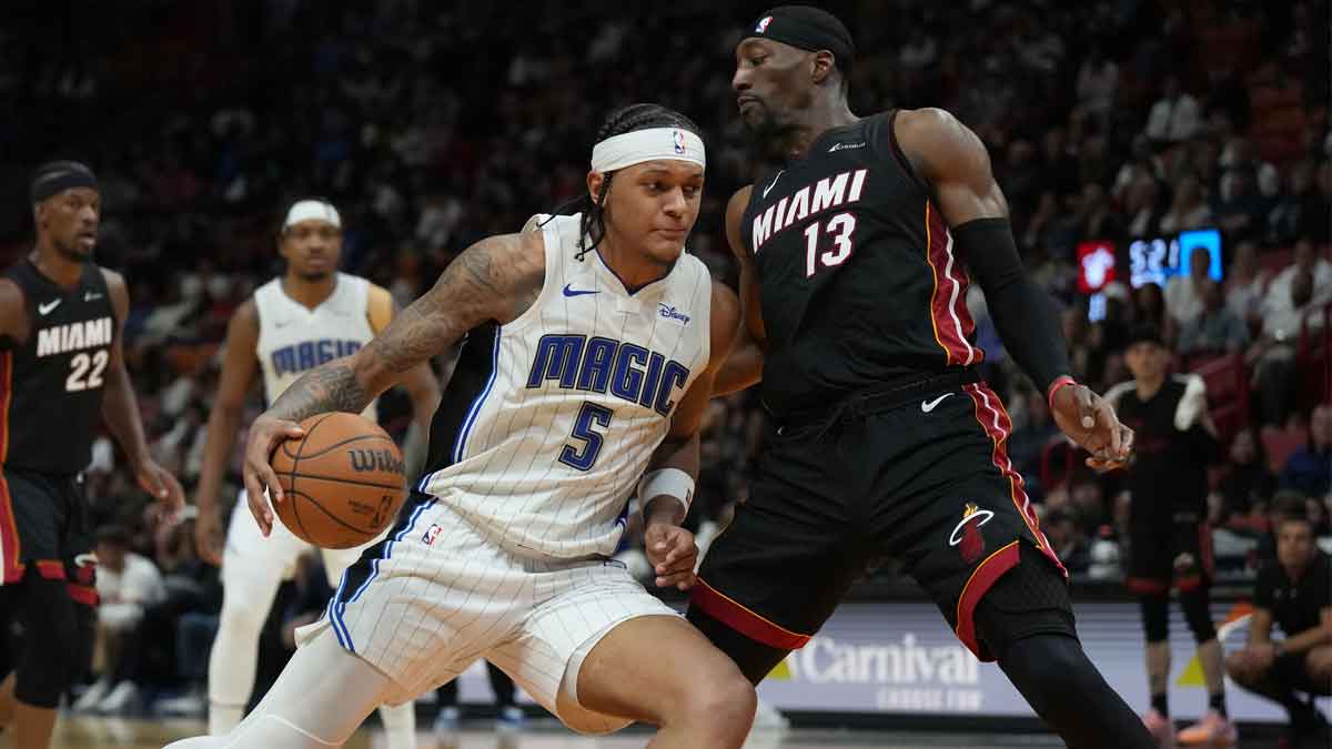 Orlando Magic forward Paolo Banchero (5) drives to the basket as Miami Heat center Bam Adebayo (13) defends during the second half at Kaseya Center.