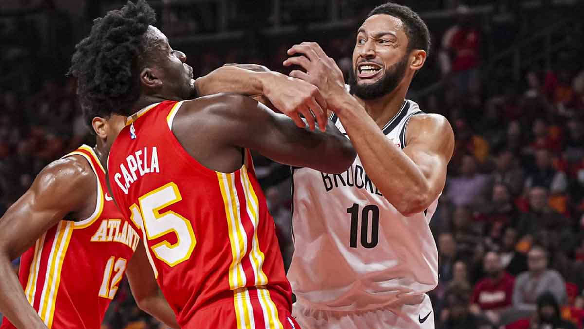 Atlanta Hawks center Clint Capela (15) and Brooklyn Nets guard Ben Simmons (10) fight for the ball during the first half at State Farm Arena.