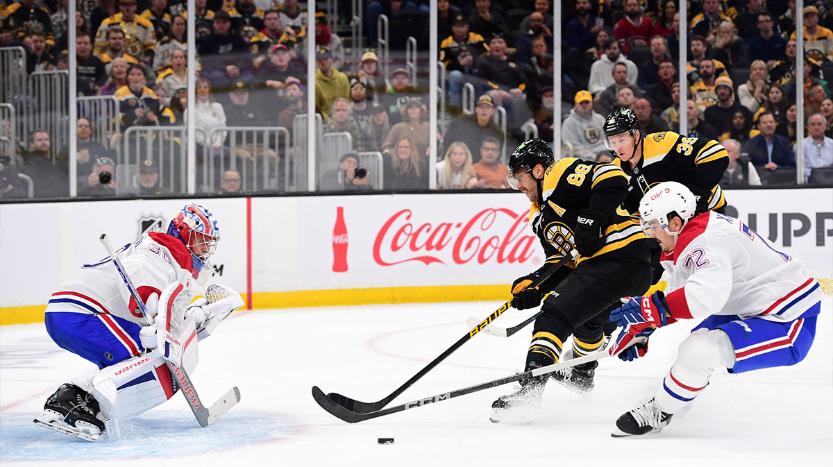 Montreal Canadiens defenseman Arber Xhekaj (72) defends Boston Bruins right winger David Pastrnak (88) against goaltender Cayden Primeau (30) during the first period at TD Garden.