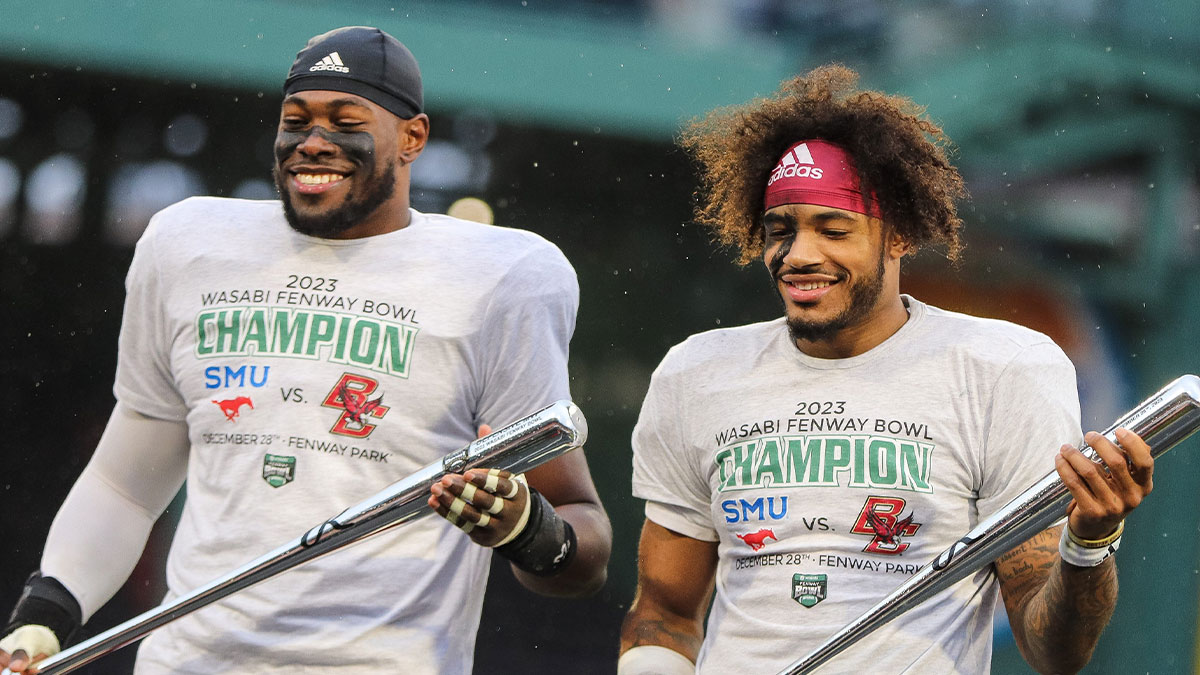 Boston College's Kam Arnold, left, and Thomas Castellanos receive game MVP honors during the second annual Wasabi Fenway Bowl vs. SMU at Fenway Park on Thursday, Dec. 28, 2023.