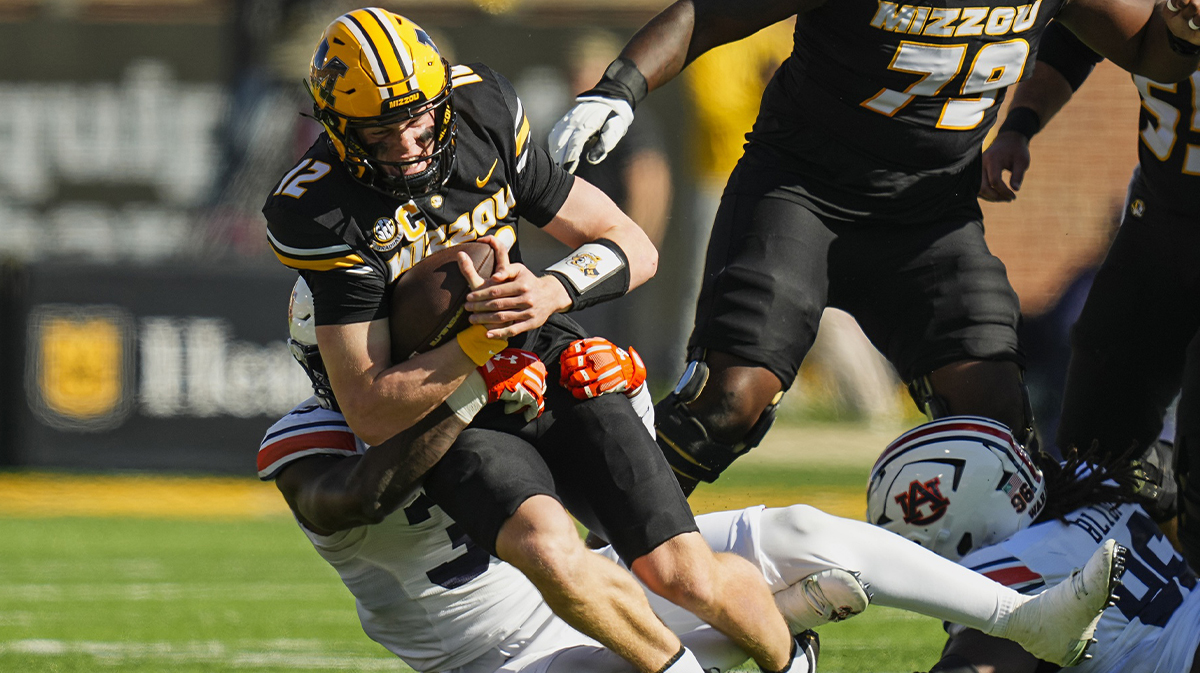 Missouri Tigers quarterback Brady Cook (12) is tackled by Auburn Tigers nose tackle Jalen McLeod (35) during the first half at Faurot Field at Memorial Stadium.