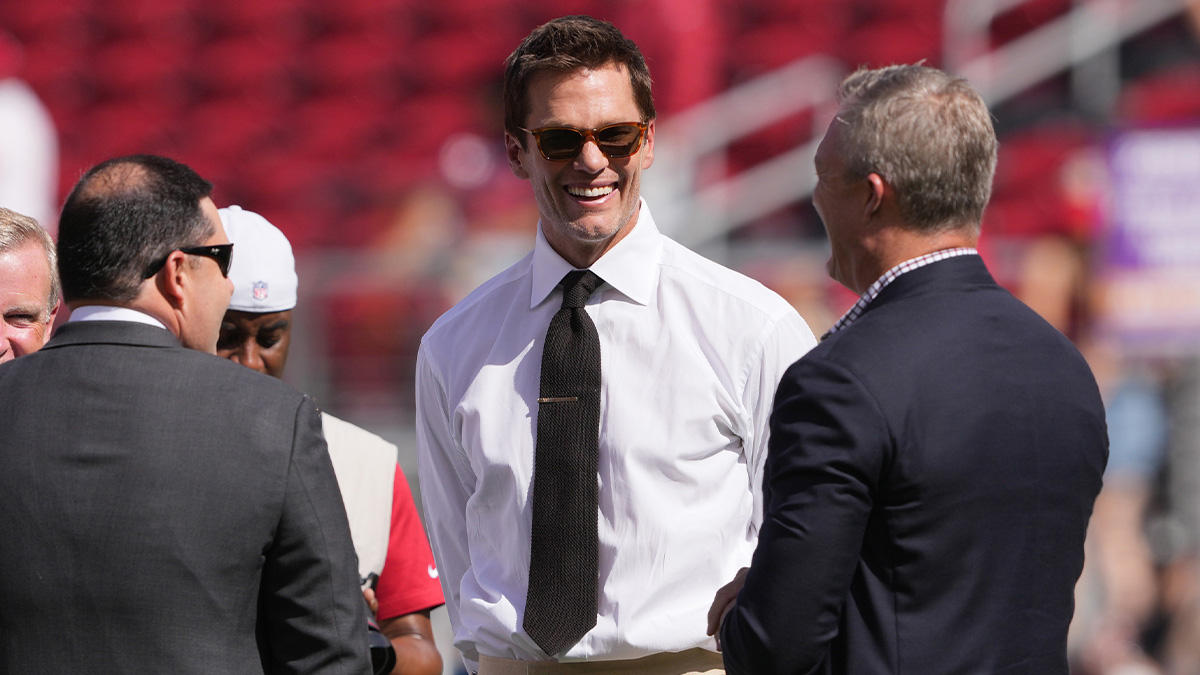 Fox color commentator Tom Brady (center) talks with San Francisco 49ers CEO Jed York (left) and general manager John Lynch (right) before the game against the Arizona Cardinals at Levi's Stadium.