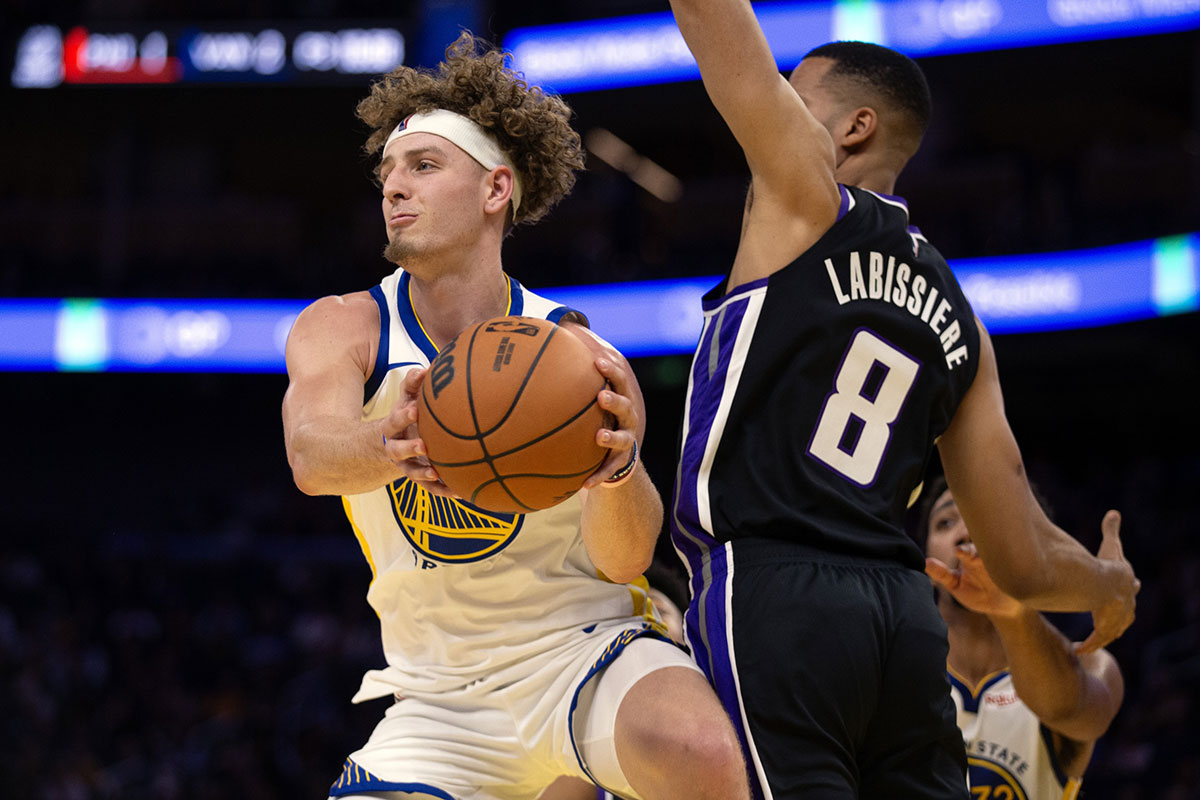 Warriors guard Brandin Podziemski (2) looks to pass away from pressure by Sacramento Kings forward Skal Labissiere (8) during the fourth quarter at Chase Center