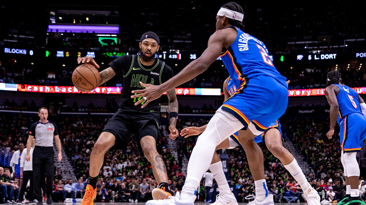 New Orleans Pelicans forward Brandon Ingram (14) dribbles against Oklahoma City Thunder guard Shai Gilgeous-Alexander (2) during game four of the first round for the 2024 NBA playoffs at Smoothie King Center.