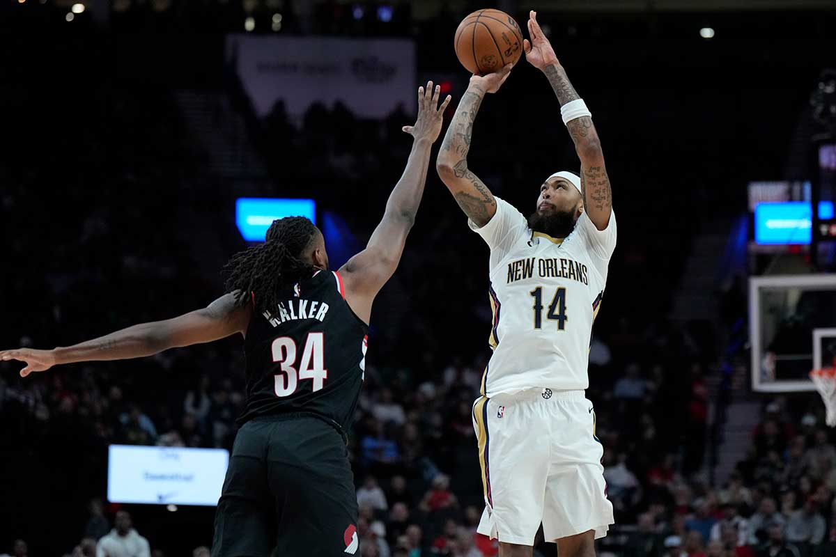 New Orleans Pelicans small forward Brandon Ingram (14) shoots the ball over Portland Trail Blazers forward Jabari Walker (34) during the first half at Moda Center.