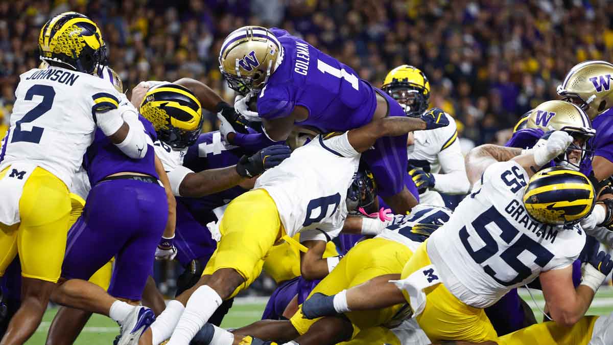 Oct 5, 2024; Seattle, Washington, USA; Washington Huskies running back Jonah Coleman (1) rushes for a touchdown over Michigan Wolverines defensive back Brandyn Hillman (6) during the fourth quarter at Alaska Airlines Field at Husky Stadium.