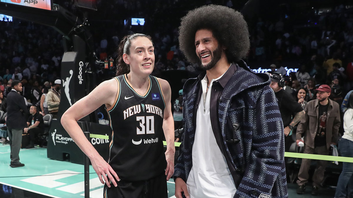 New York Liberty forward Breanna Stewart (30) talks with former NFL quarterback Colin Kaepernick after defeating Las Vegas Aces 88-84 in game two of the 2024 WNBA Semi-finals at Barclays Center.