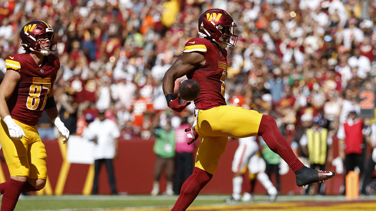 Washington Commanders running back Brian Robinson Jr. (8) celebrates after scoring a touchdown against the Cleveland Browns during the second quarter at NorthWest Stadium.