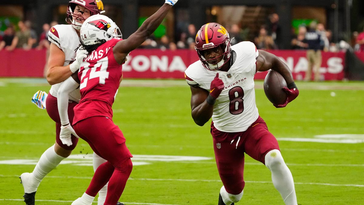 Commanders running back Brian Robinson Jr. (8) runs for a first down against the Cardinals during a game at State Farm Stadium in in Glendale on Sept. 29, 2024.