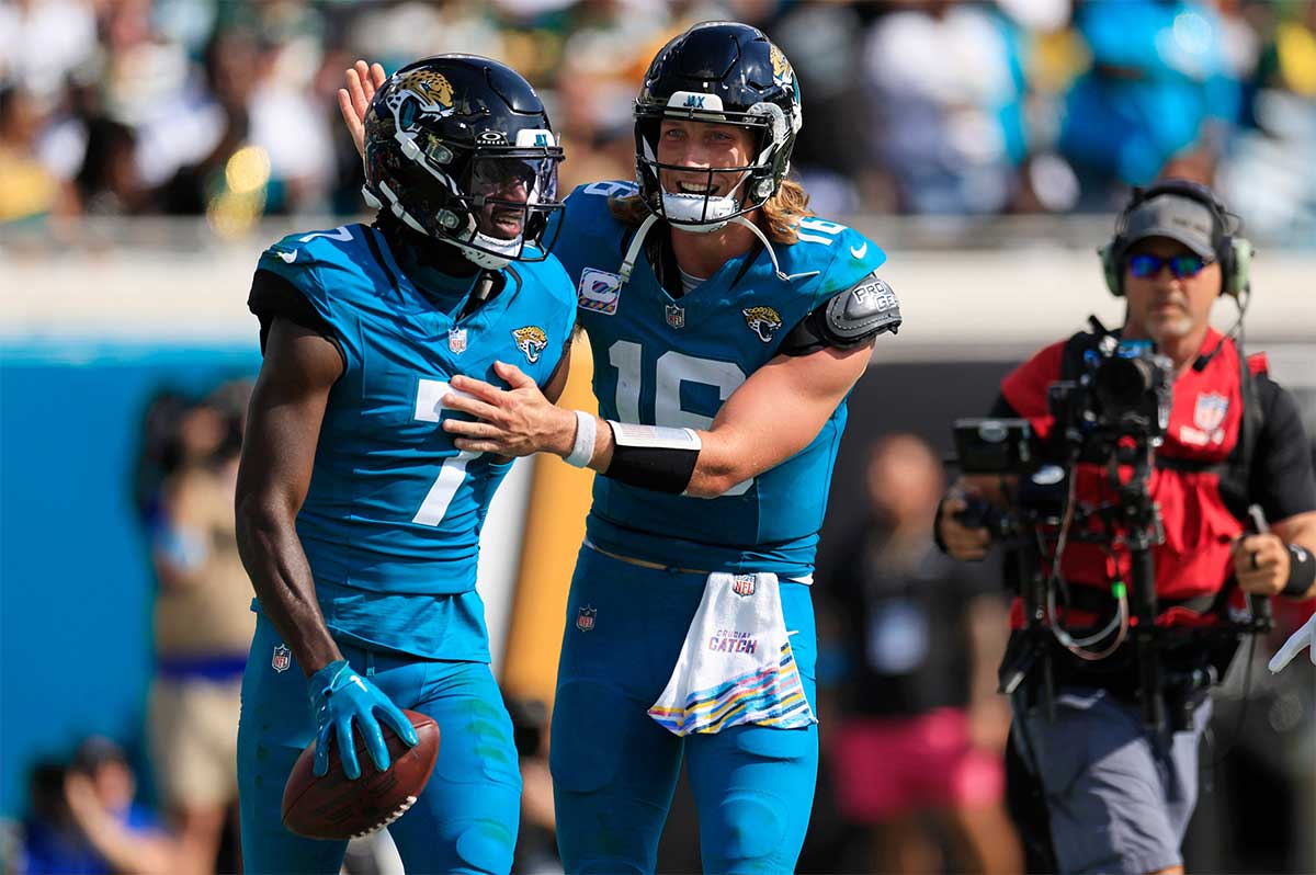 Jacksonville Jaguars quarterback Trevor Lawrence (16) congratulates wide receiver Brian Thomas Jr. (7) on his touchdown score during the third quarter of an NFL football matchup Sunday, Oct. 27, 2024 at EverBank Stadium in Jacksonville, Fla. The Packers edged the Jaguars 30-27 on a last-second field goal.