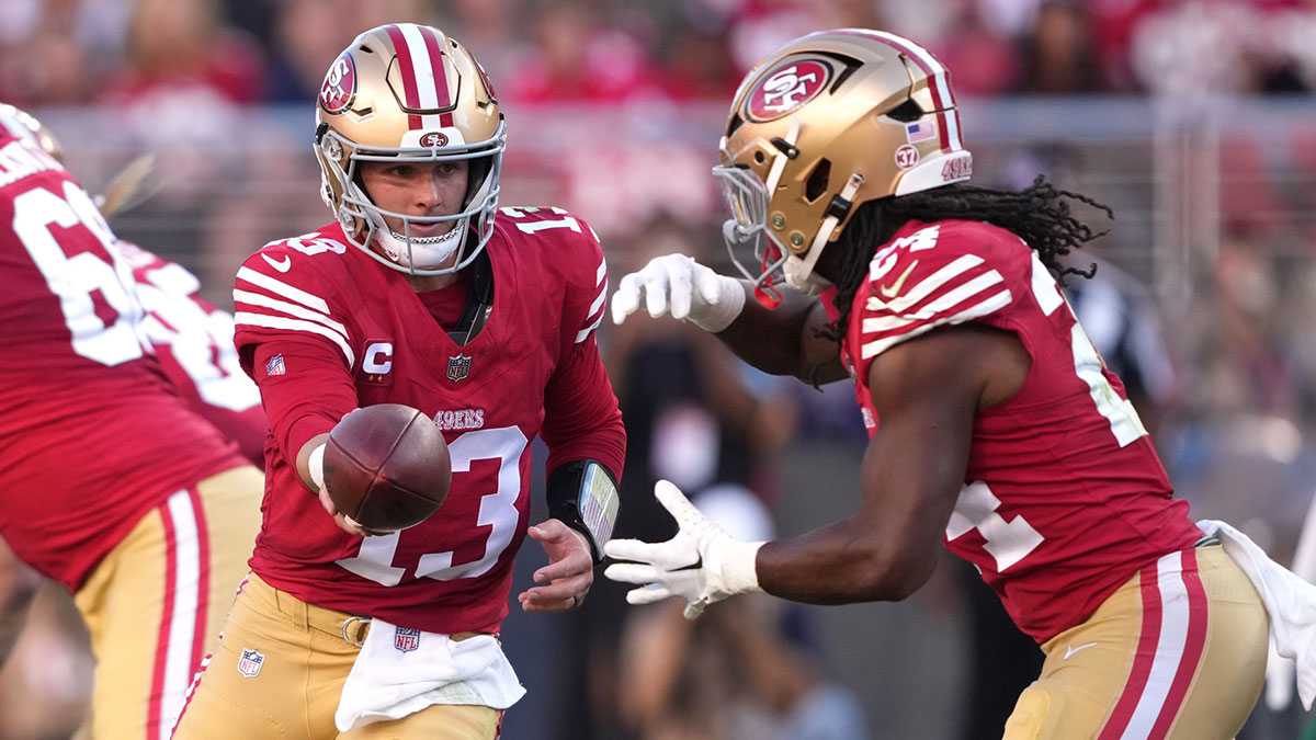 San Francisco 49ers quarterback Brock Purdy (13) hands off to running back Jordan Mason (right) during the second quarter at Levi's Stadium.