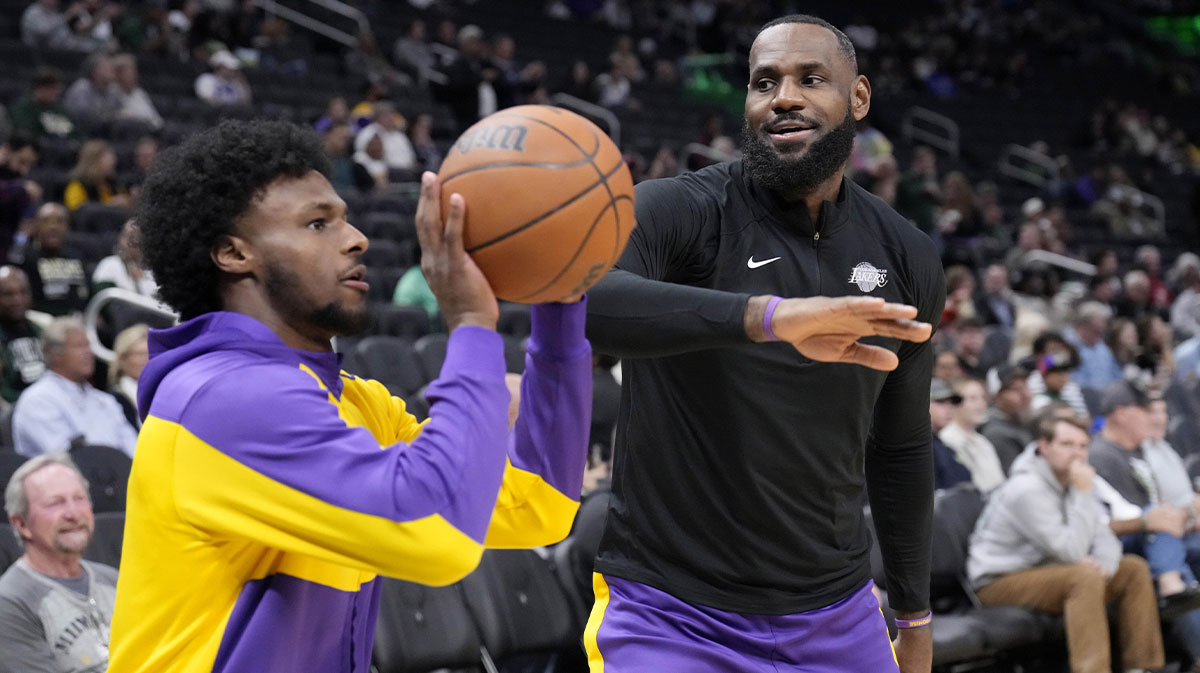 Los Angeles Lakers forward LeBron James (23) goofs around with his son guard Bronny James (9) during warm ups before their game against the Milwaukee Bucks at Fiserv Forum.