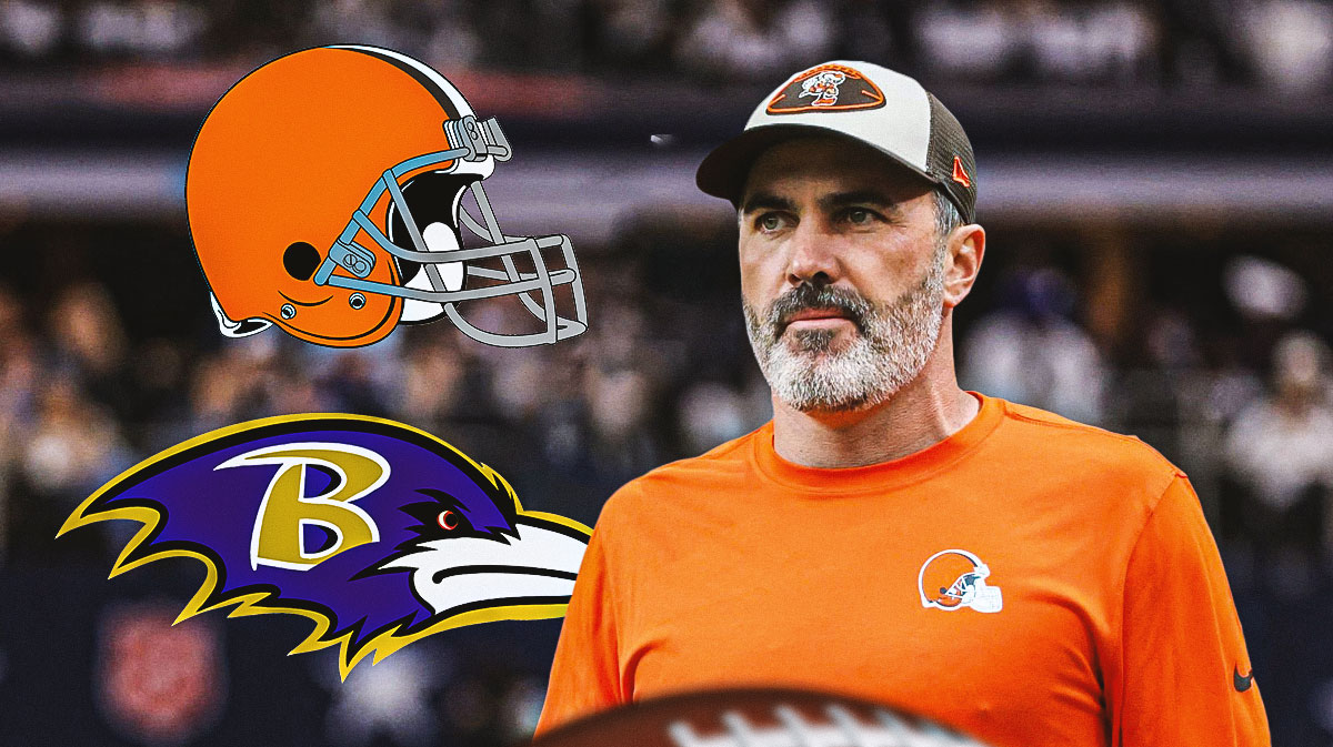 Browns head coach Kevin Stefanski next to the Browns & Ravens logos