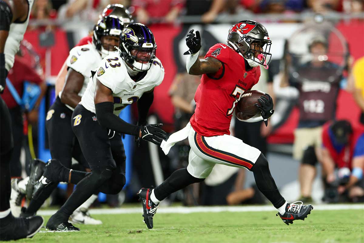 October 21, 2024; Tampa, Florida, USA; Tampa Bay Buccaneers running back Bucky Irving (7) runs with the ball against the Baltimore Ravens in the first quarter at Raymond James Stadium.