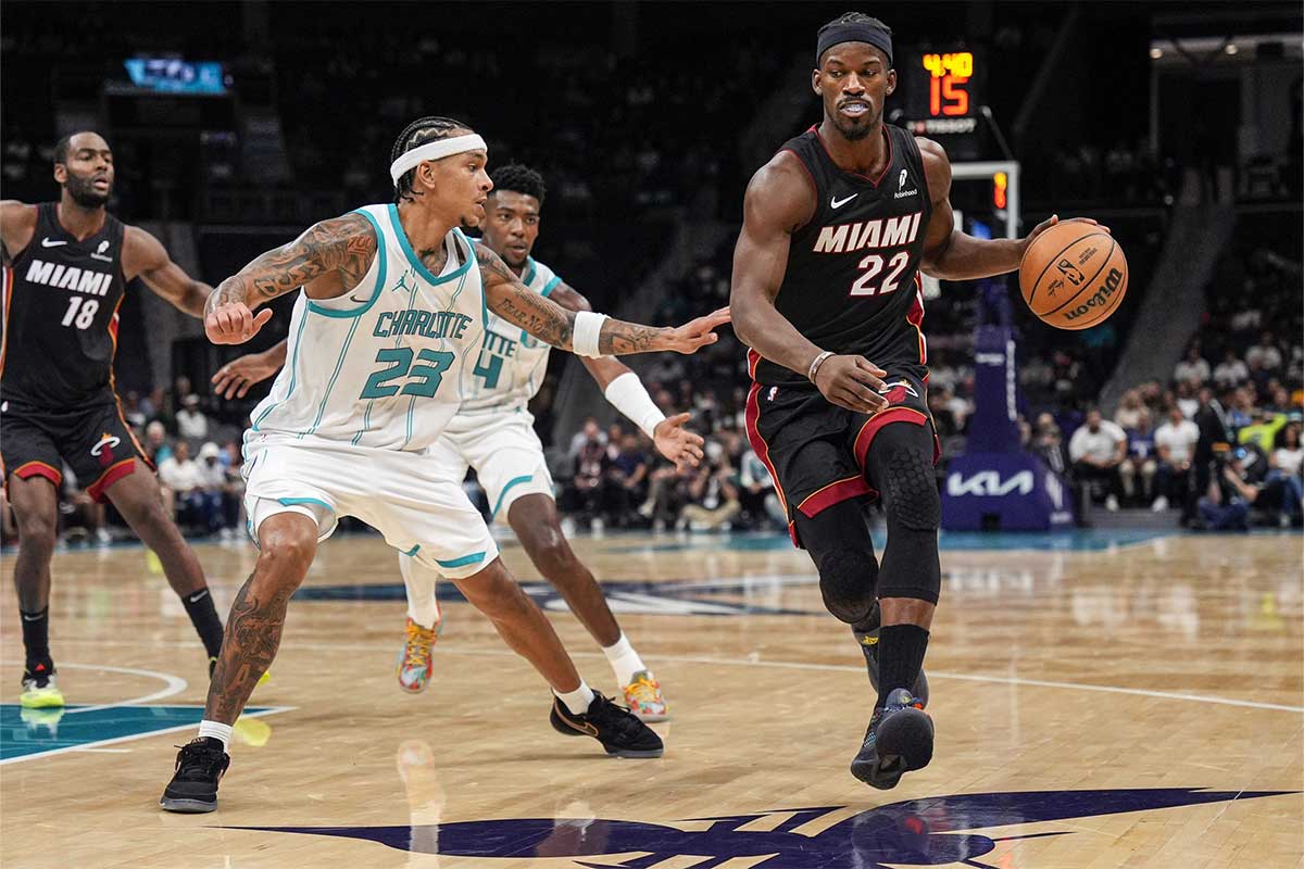 Charlotte Hornets guard Tre Mann (23) guards Miami Heat forward Jimmy Butler (22) during the second quarter at Spectrum Center.