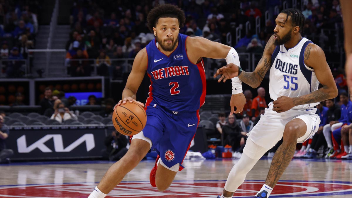 Detroit Pistons guard Cade Cunningham (2) dribbles defended by Dallas Mavericks forward Derrick Jones Jr. (55) in the second half at Little Caesars Arena.