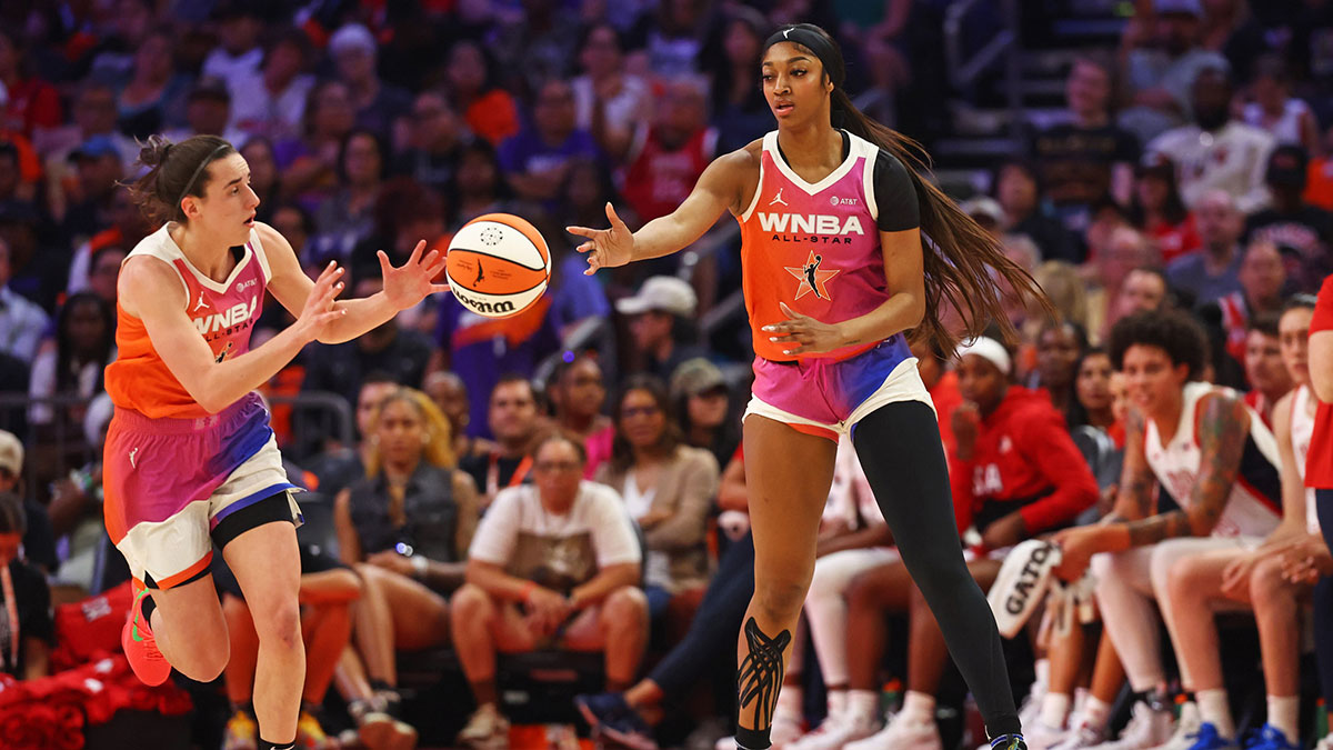 Team WNBA forward Angel Reese (5) passes the ball to Team WNBA guard Caitlin Clark (22) during the first half against the USA Women's National Team at Footprint Center.