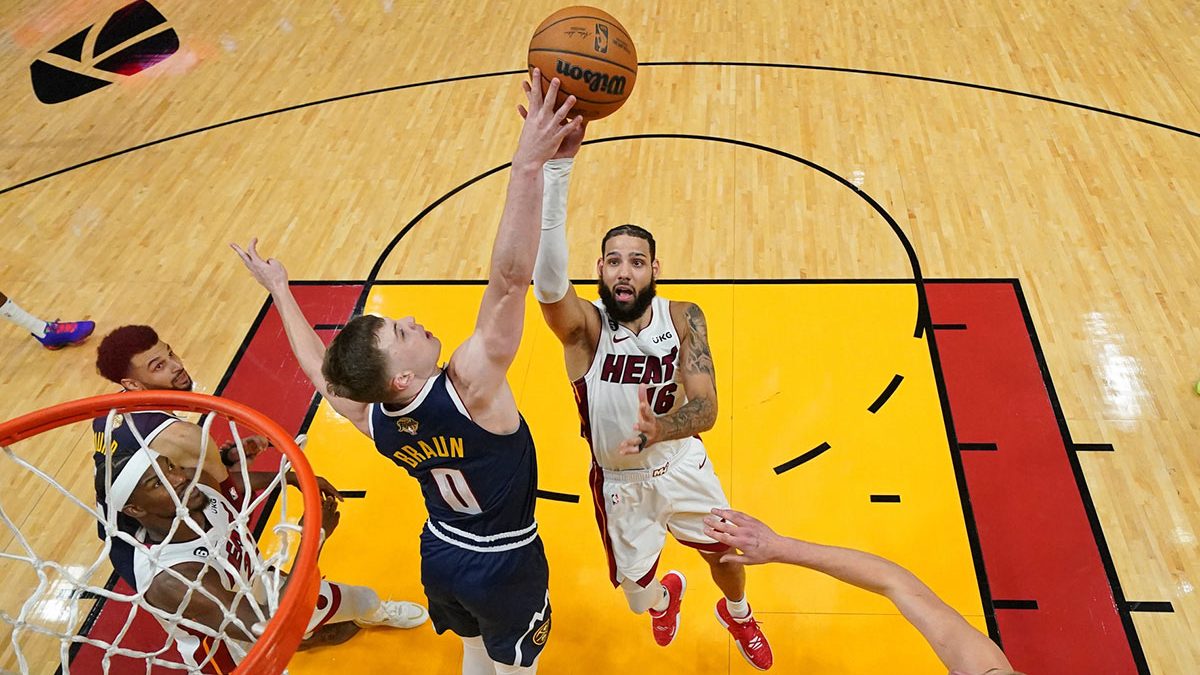 Denver Nuggets guard Christian Braun (0) blocks the shot of of Miami Heat forward Caleb Martin (16) during the second half in game four of the 2023 NBA Finals at Kaseya Center.