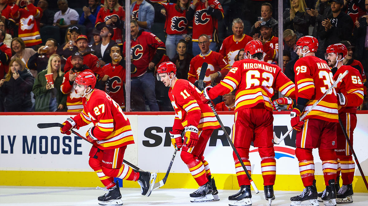 Calgary Flames right wing Matt Coronato (27) celebrates his goal with teammates against the Chicago Blackhawks during the third period at Scotiabank Saddledome.