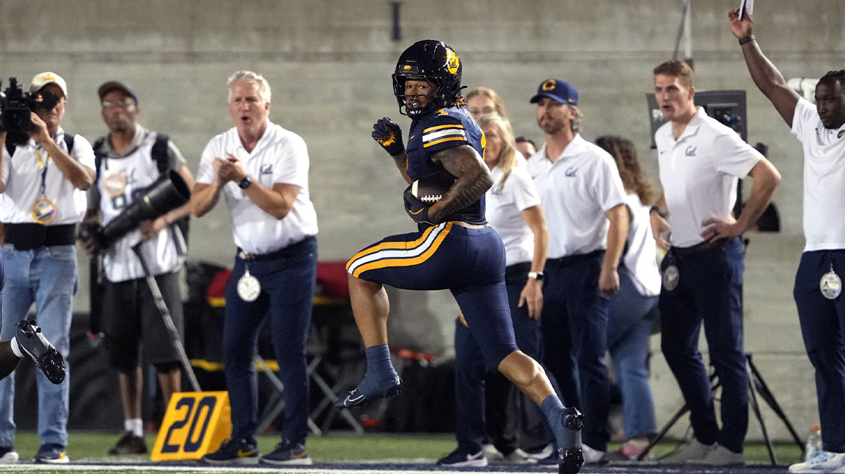 California Golden Bears running back Jaydn Ott (1) runs after a catch to score a touchdown against the Miami Hurricanes during the second quarter at California Memorial Stadium.