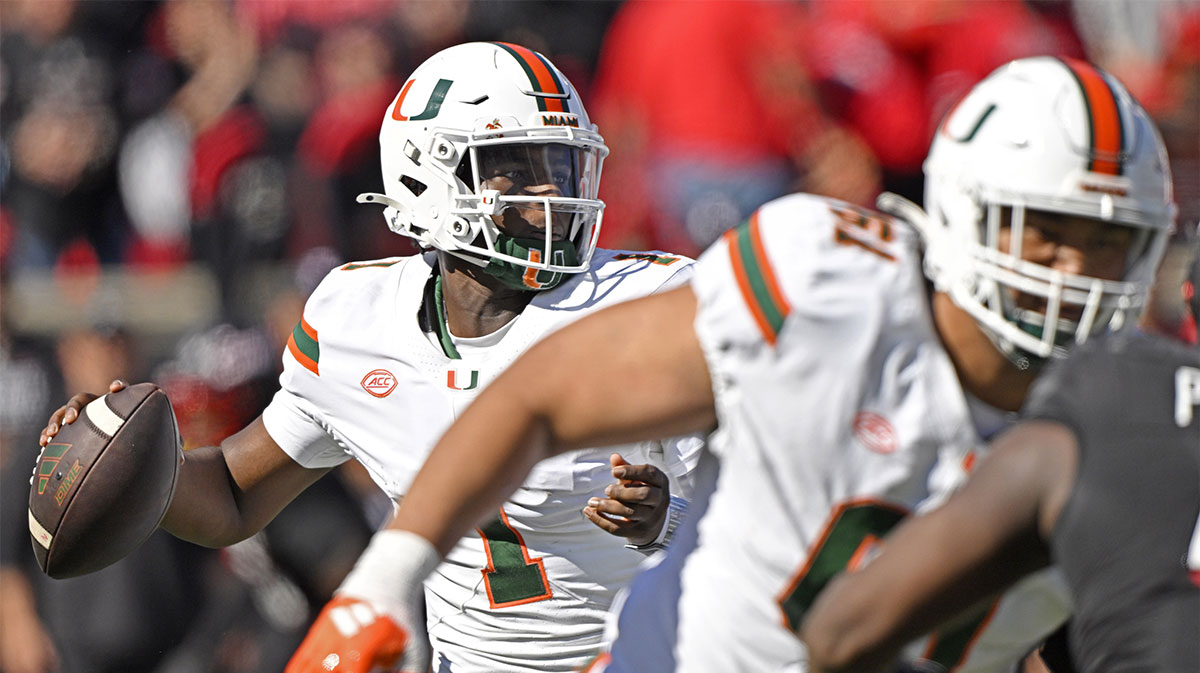 Miami Hurricanes quarterback Cam Ward (1) looks to pass against the Louisville Cardinals during the first half at L&N Federal Credit Union Stadium. Miami defeated Louisville 52-45.