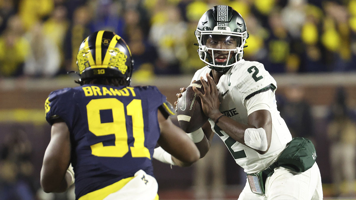 Michigan Wolverines defensive end Cameron Brandt (91) pressures Michigan State Spartans quarterback Aidan Chiles (2) in the second half at Michigan Stadium.
