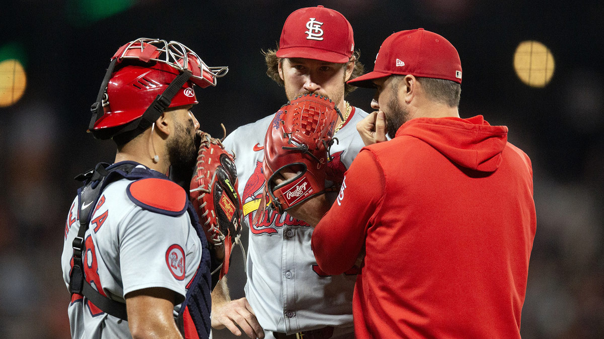 St. Louis Cardinals catcher Iván Herrera (48) and starting pitcher Miles Mikolas (39) confer with pitching coach Dusty Blake during the second inning against the San Francisco Giants at Oracle Park.