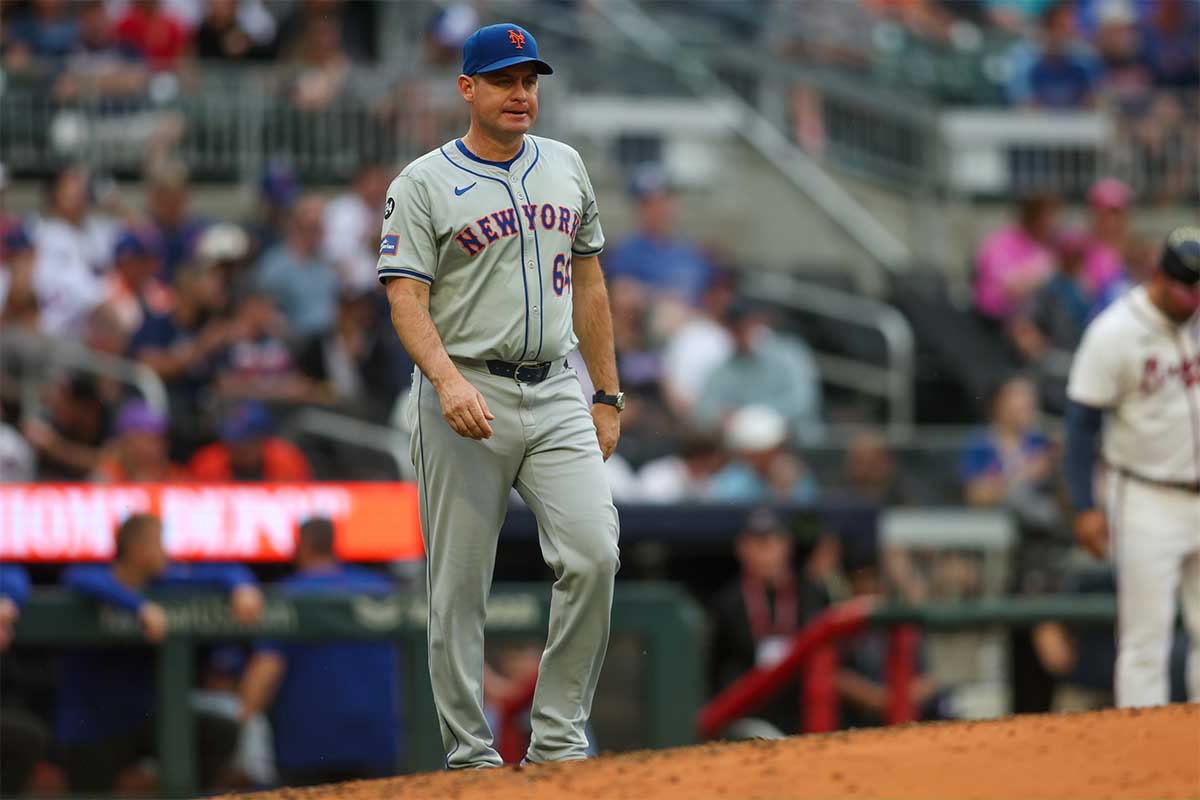 New York Mets manager Carlos Mendoza (64) makes a pitching change against the Atlanta Braves in the sixth inning at Truist Park.