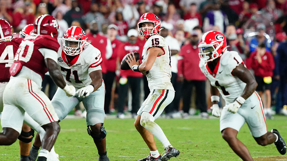Georgia Bulldogs quarterback Carson Beck (15) drops back to throw against the Alabama Crimson Tide during the fourth quarter at Bryant-Denny Stadium.