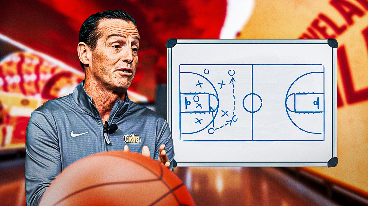 Kenny Atkinson next to a dry-erase board with offensive schemes featuring a Cavs-themed bg.