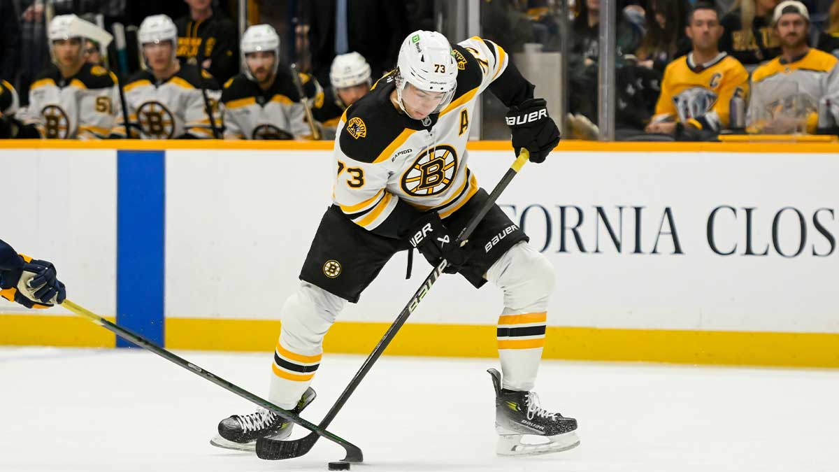 Boston Bruins defenseman Charlie McAvoy (73) takes a shot against the Nashville Predators during the second period at Bridgestone Arena.