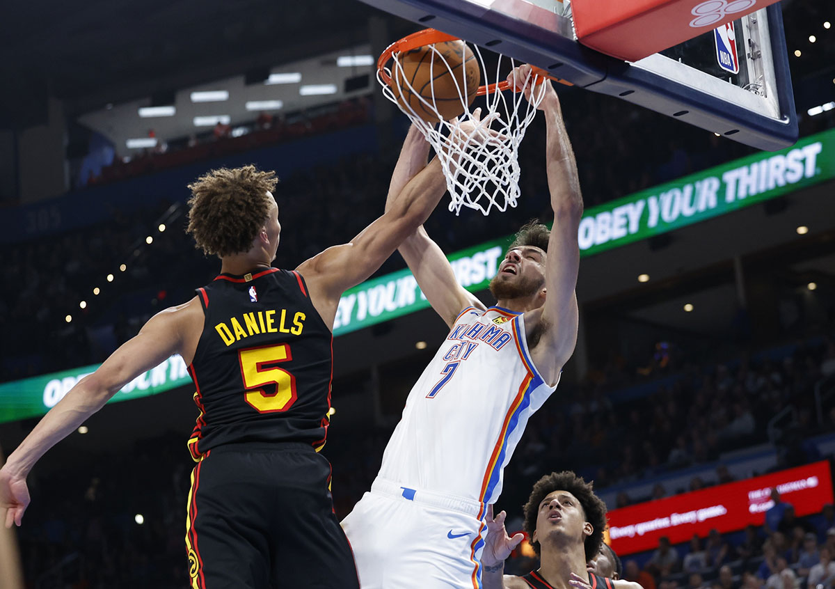 Oklahoma City Thunder forward Chet Holmgren (7) dunks in front of Atlanta Hawks guard Dyson Daniels (5) during the second half at Paycom Center.