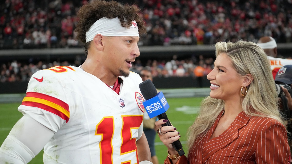 Kansas City Chiefs quarterback Patrick Mahomes (15) is interviewed by CBS Sports reporter Melanie Collins after the game against the Las Vegas Raiders at Allegiant Stadium.