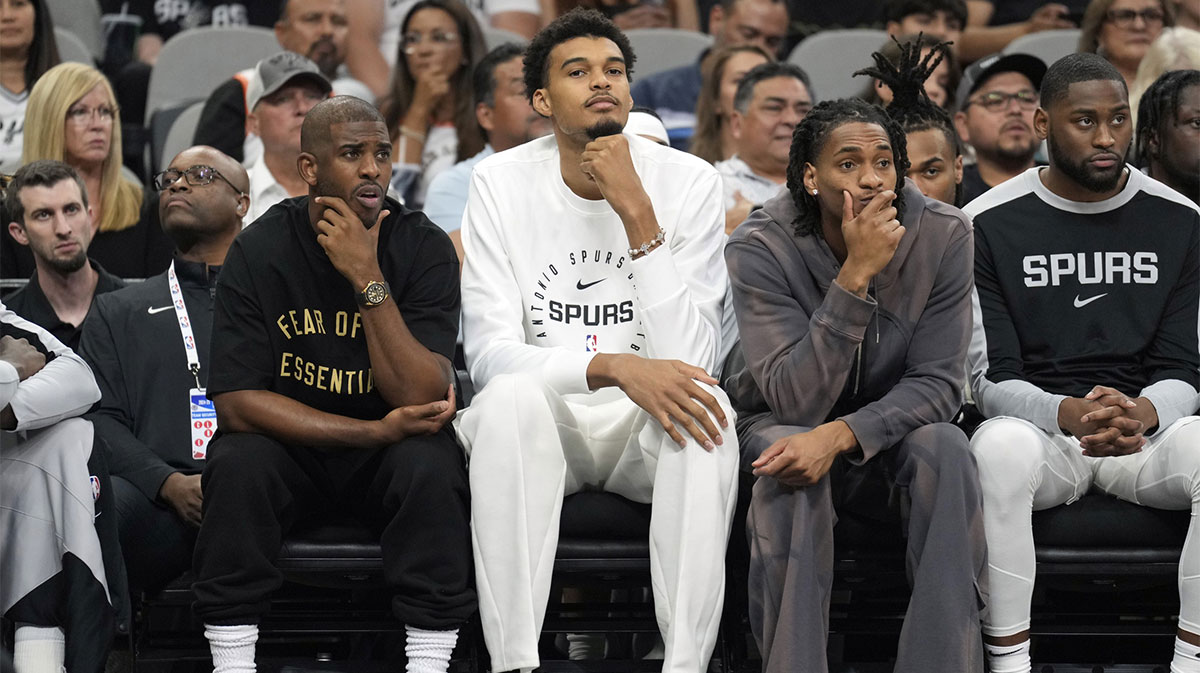 San Antonio Spurs center Victor Wembanyama (1) along with guards Chris Paul (3) and Devin Vassell (24) sit out the preseason game against the Oklahoma City Thunder at Frost Bank Center.