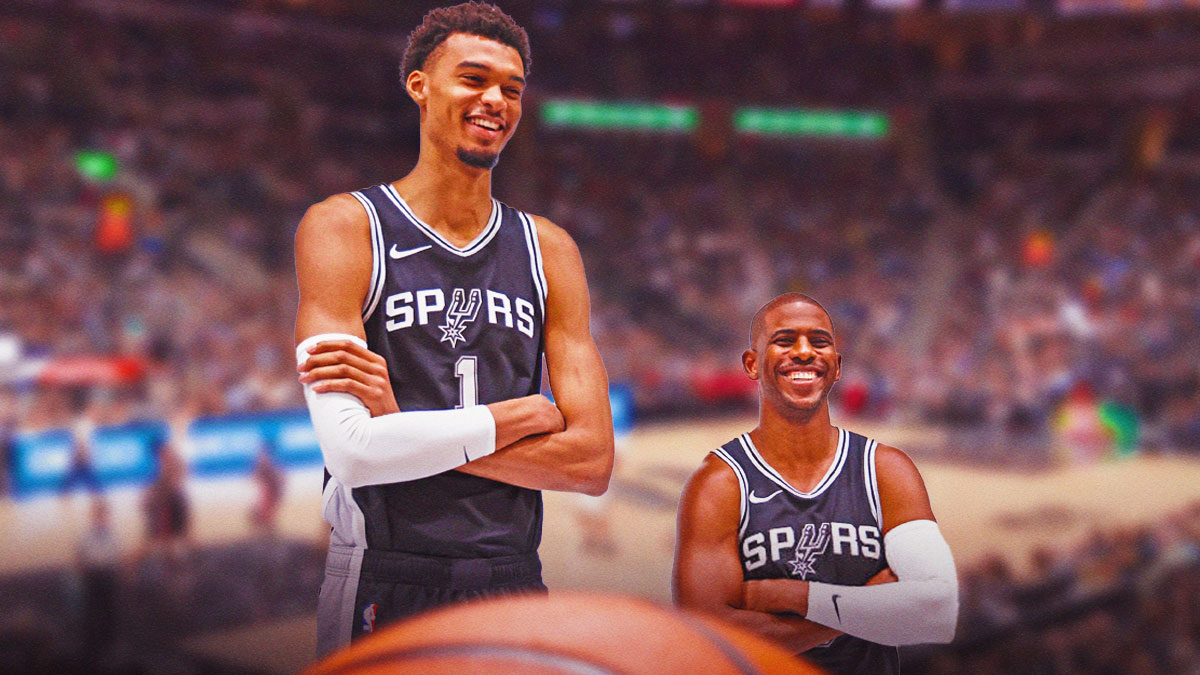 Chris Paul beside Victor Wembanyama both wearing Spurs gear