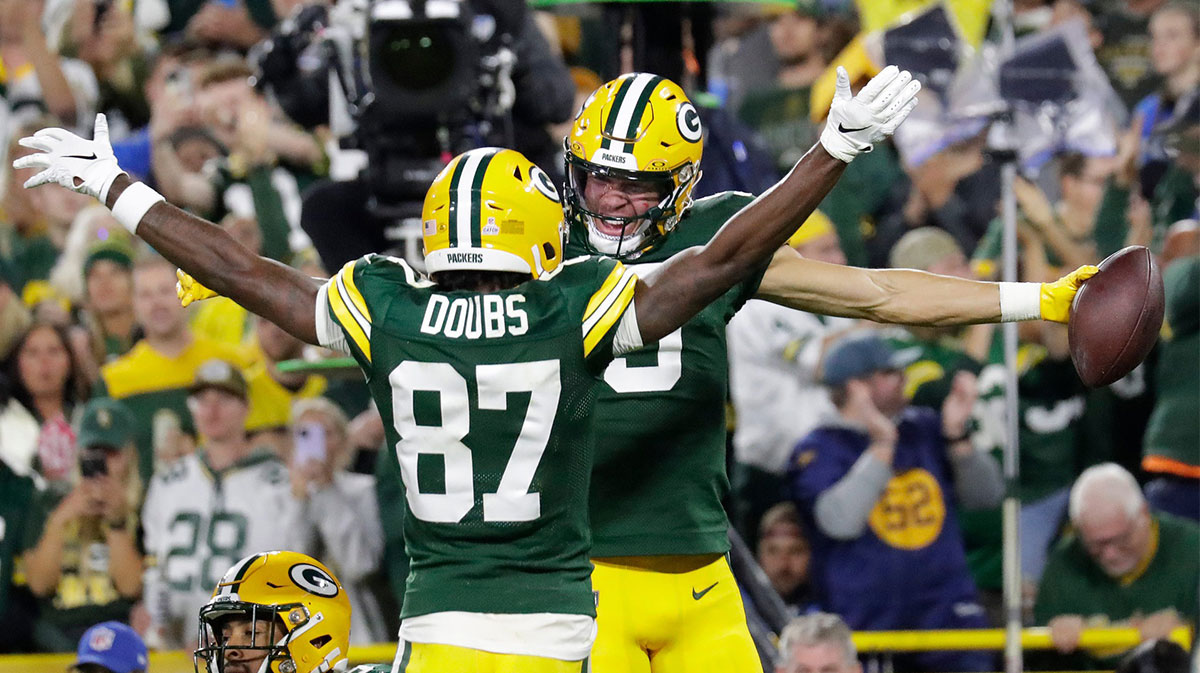 Green Bay Packers wide receiver Christian Watson (9) celebrates with wide receiver Romeo Doubs (87) after scoring a touchdown against the Detroit Lions