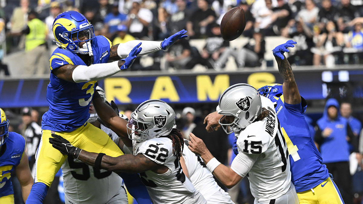 Los Angeles Rams cornerback Cobie Durant (14) knocks the ball out of the hands of Las Vegas Raiders quarterback Gardner Minshew (15) during the second quarter at SoFi Stadium. The ball was recovered by Los Angeles Rams safety Kamren Curl (3) and runback for a touchdown.