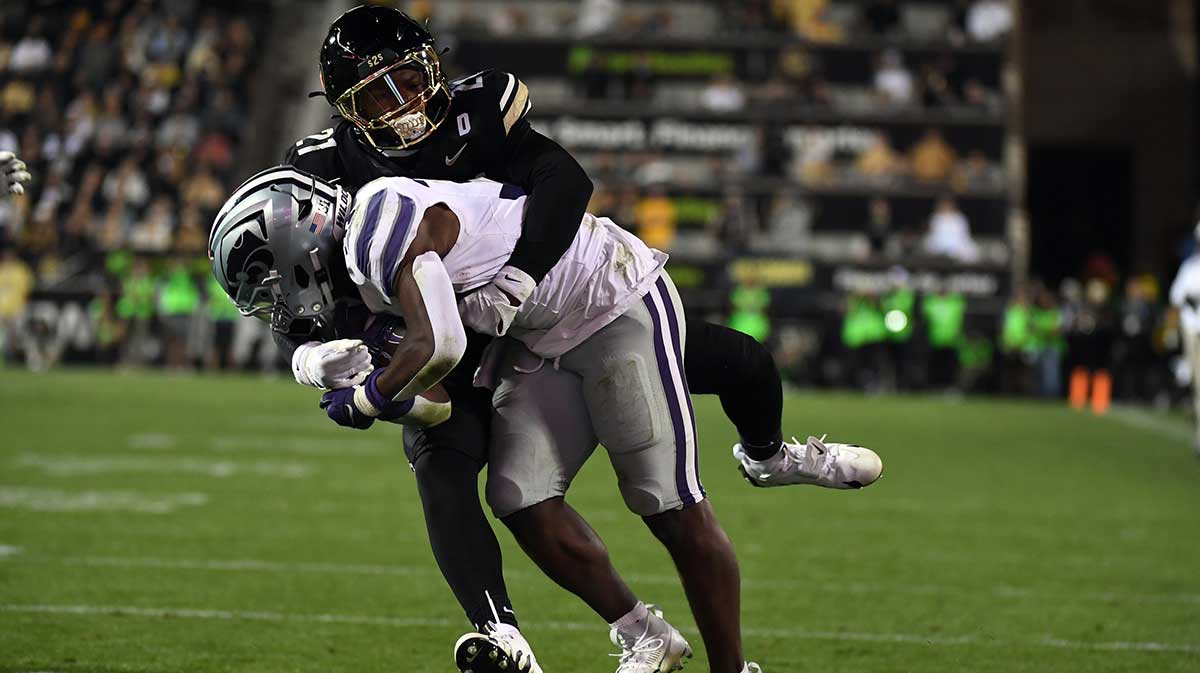 Oct 12, 2024; Boulder, Colorado, USA; Kansas State Wildcats running back DJ Giddens (31) runs for a short gain as he is tackled by Colorado Buffaloes safety Shilo Sanders (21)