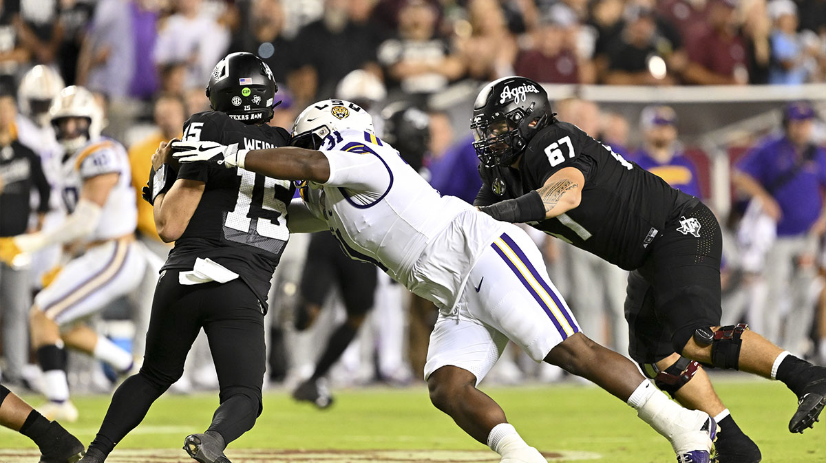 LSU Tigers defensive tackle Jay'viar Suggs (31) applies pressure to Texas A&M Aggies quarterback Conner Weigman (15) during the third quarter. The Aggies defeated the Tigers 38-23; at Kyle Field.