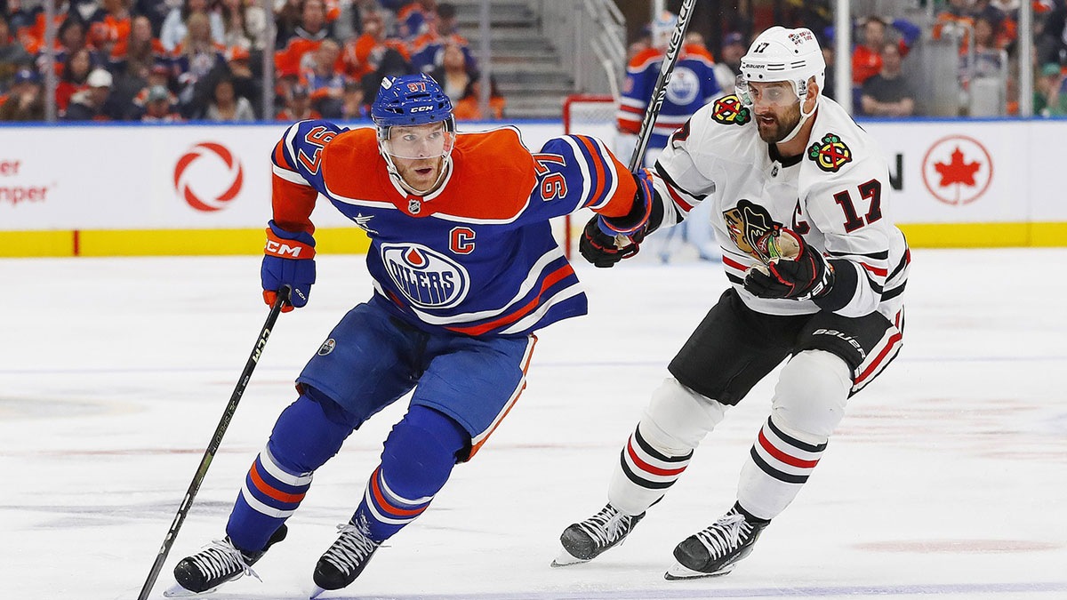 Edmonton Oilers forward Connor McDavid (97) carries the puck around Chicago Blackhawks forward Nick Foligno (17) during the third period at Rogers Place.