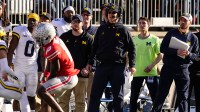 Michigan Wolverines head coach Jim Harbaugh watches from the sideline beside off-field analyst Connor Stalions, right, during the NCAA football game against the Ohio State Buckeyes at Ohio Stadium.