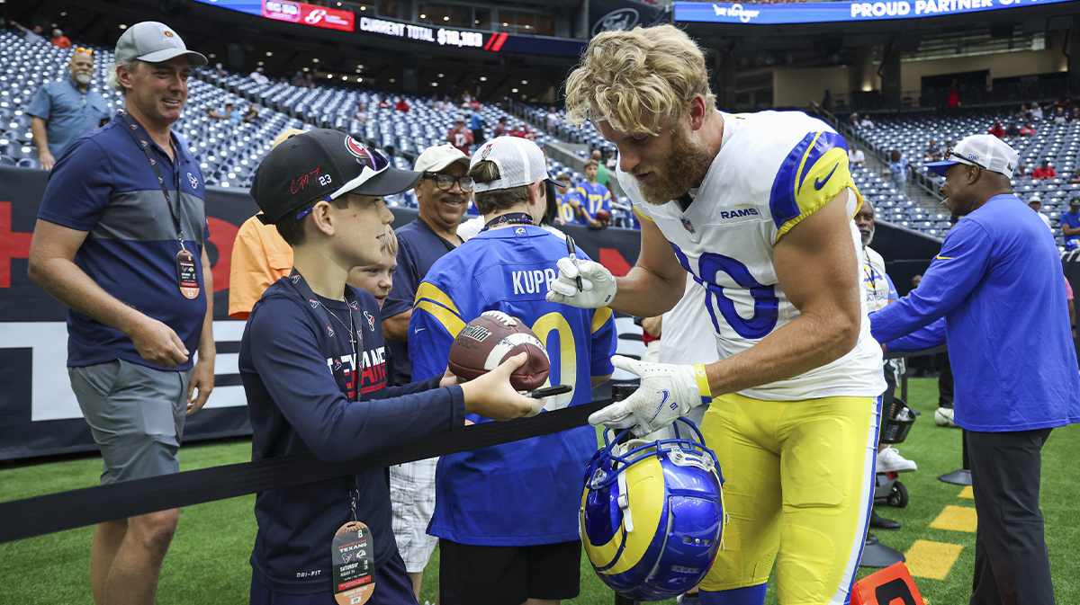 Los Angeles Rams wide receiver Cooper Kupp (10) signs autographs before the game against the Houston Texans at NRG Stadium.