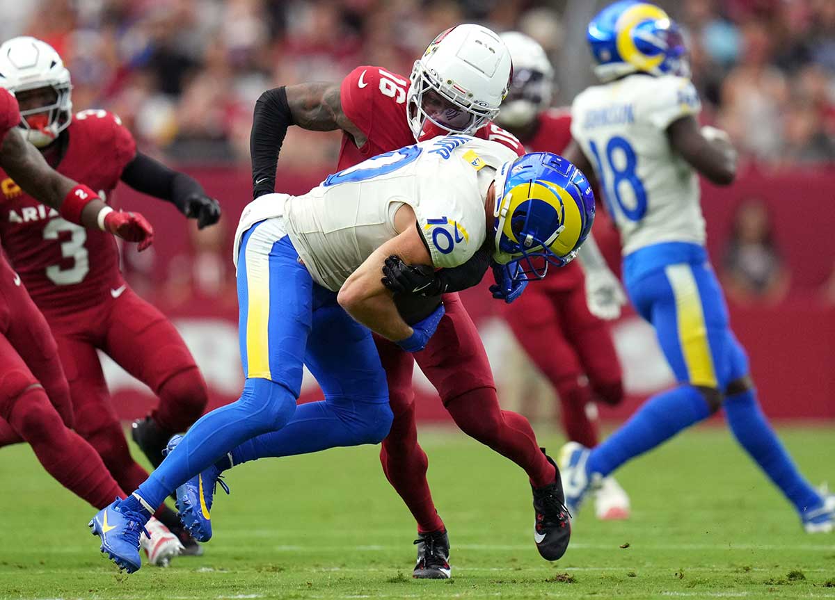 Arizona Cardinals cornerback Max Melton (16) tackles Los Angeles Rams receiver Cooper Kupp