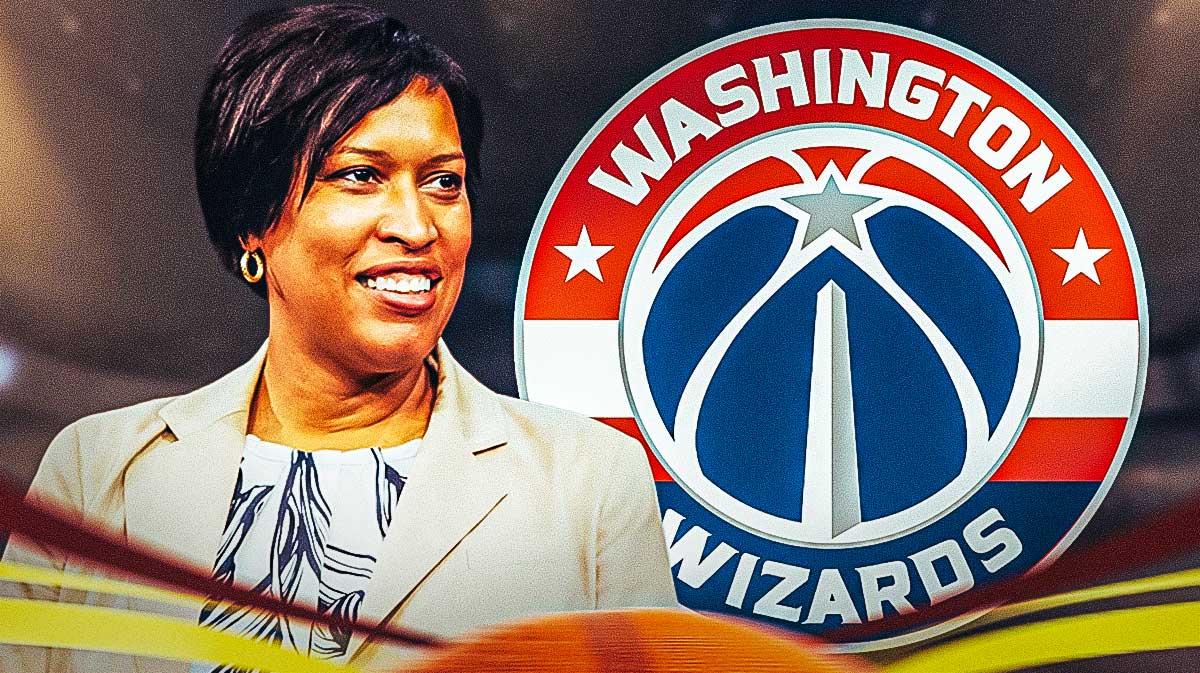 Muriel Bowser smiles next to Wizards logo