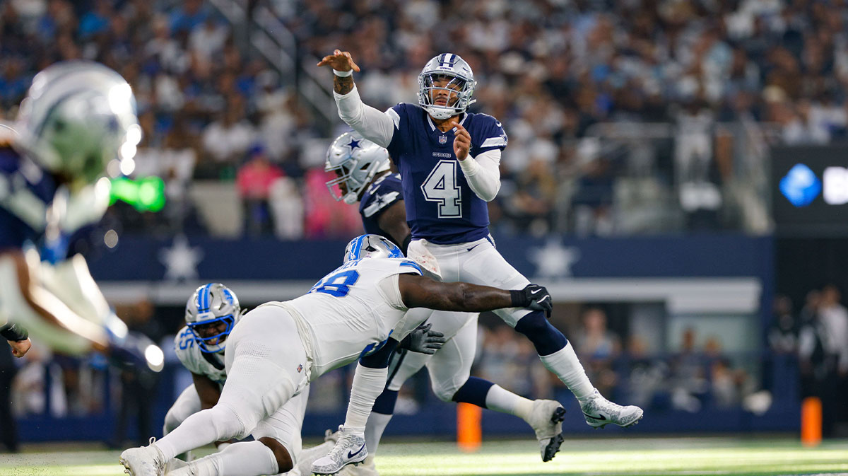 Dallas Cowboys quarterback Dak Prescott (4) throws a pass while being pressured by Detroit Lions defensive tackle DJ Reader (98) during the third quarter at AT&T Stadium. 